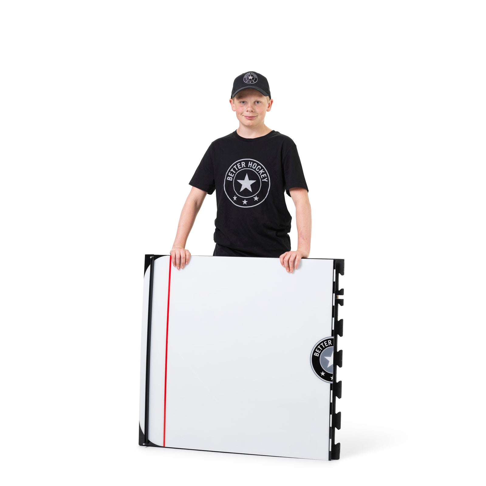 Young hockey player stickhandling on the Game Changer training board in hockey gear
