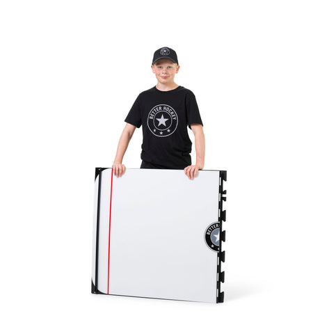 Young hockey player stickhandling on the Game Changer training board in hockey gear