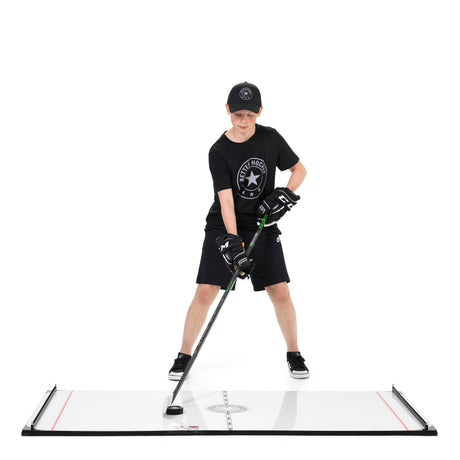 Young hockey player stickhandling a sensor puck on the Game Changer training board