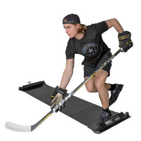 Young hockey player in a deep knee bend doing lateral edge work on an Extreme slide board